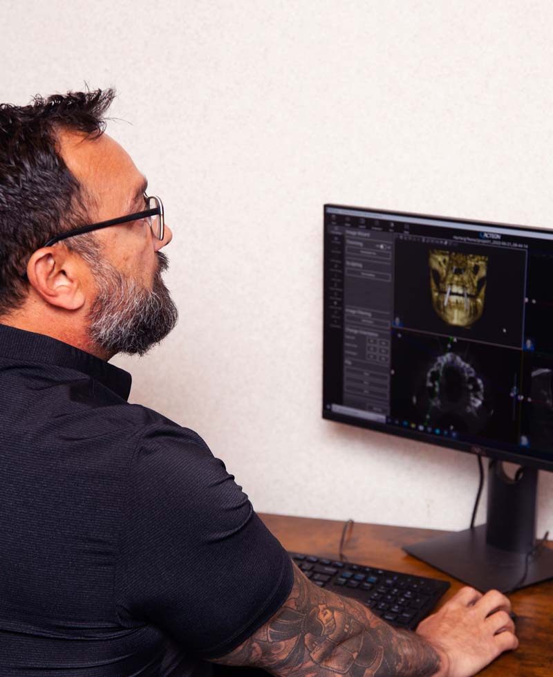 Dr. Taglia reviewing digital x-rays for biomimetic treatment
